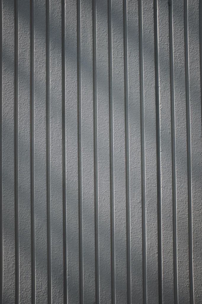 Gray wall texture with vertical panels.